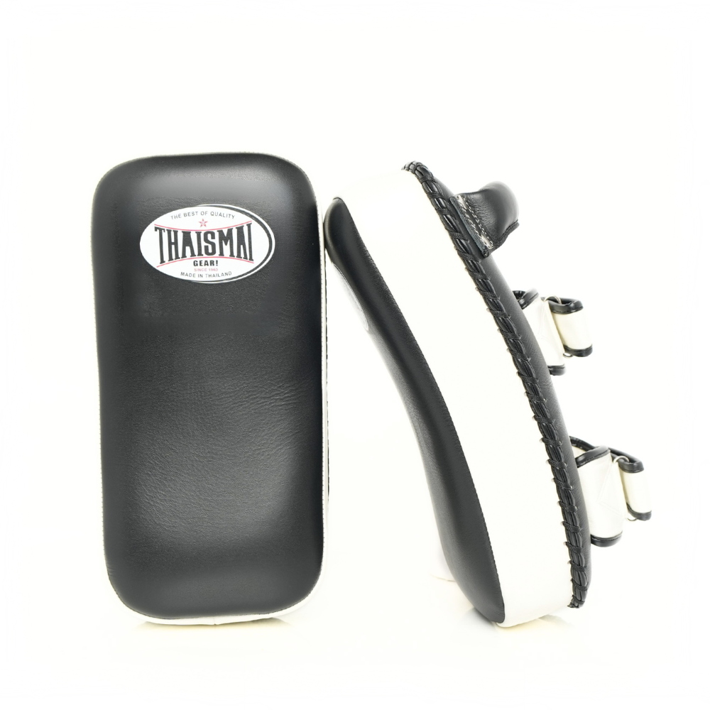THAISMAI KP142 Muay Thai kick pad in black and white, shown from the front and side to display the striking face, padded profile and fastening straps.