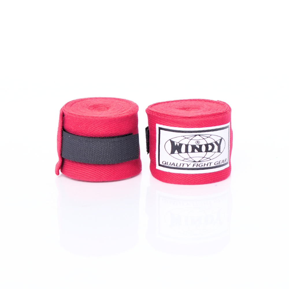 Pair of rolled red Windy hand wraps showing the logo label and closure strap