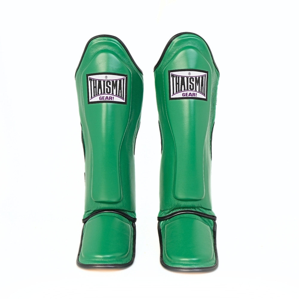 Front view of the green THAISMAI LP184 Muay Thai shin guards, showing the pair’s shin panels, THAISMAI Gear logos and padded instep sections on a white background.