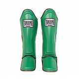 Front view of the green THAISMAI LP184 Muay Thai shin guards, showing the pair’s shin panels, THAISMAI Gear logos and padded instep sections on a white background.
