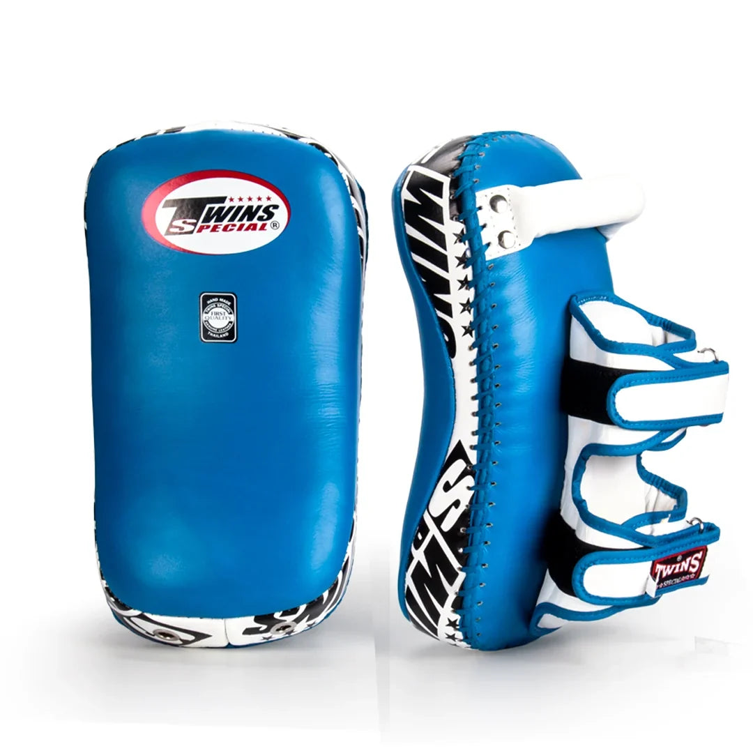 Twins Special KPL-12 Deluxe kicking pads in black and gray with dense impact padding, curved striking surface and secure dual-strap hand compartments for Muay Thai and kickboxing training on a white background