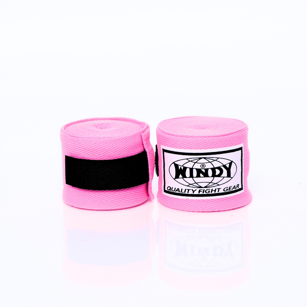Pair of rolled pink Windy hand wraps showing the logo label and closure strap