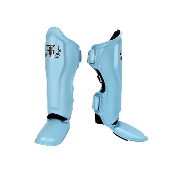 Top King TKSGP-GL Pro shin guards in black genuine leather with full-length shin and instep protection, dense impact padding and secure hook-and-loop closures for Muay Thai and kickboxing on a white background