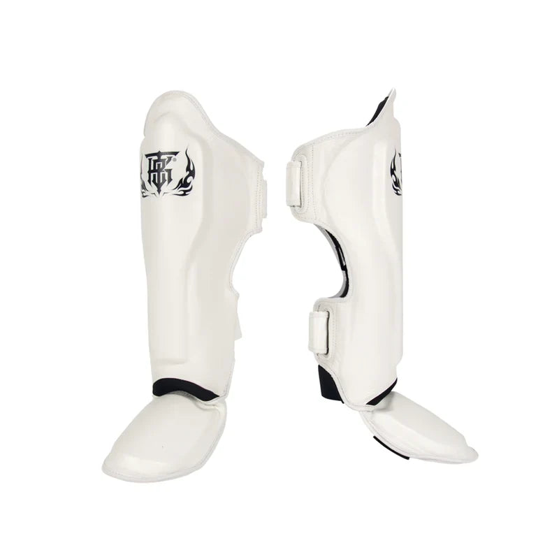 Top King TKSGP-GL Pro shin guards in black genuine leather with full-length shin and instep protection, dense impact padding and secure hook-and-loop closures for Muay Thai and kickboxing on a white background