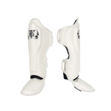 Top King TKSGP-GL Pro shin guards in black genuine leather with full-length shin and instep protection, dense impact padding and secure hook-and-loop closures for Muay Thai and kickboxing on a white background