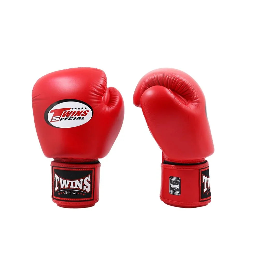 Pair of red Twins Special boxing gloves on a white background, showing the front logo on one glove and side branding on the other