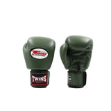 Pair of olive green Twins Special boxing gloves showing the front logo, rear padding, black wrist straps and brand patches on a white background