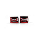 Two pairs of Twins Special boxing hand wraps with embroidered logo patches displayed on a white background