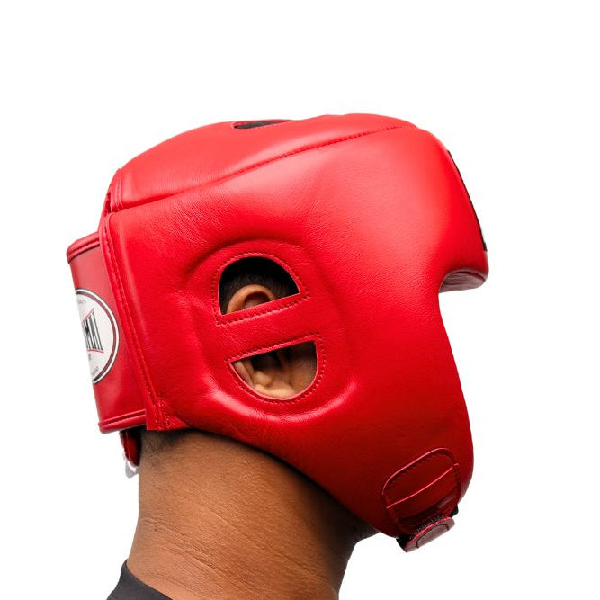 Side profile of a person wearing the red THAISMAI HG-152 head guard, showing the eye and ear openings and padded chin strap against a white background.