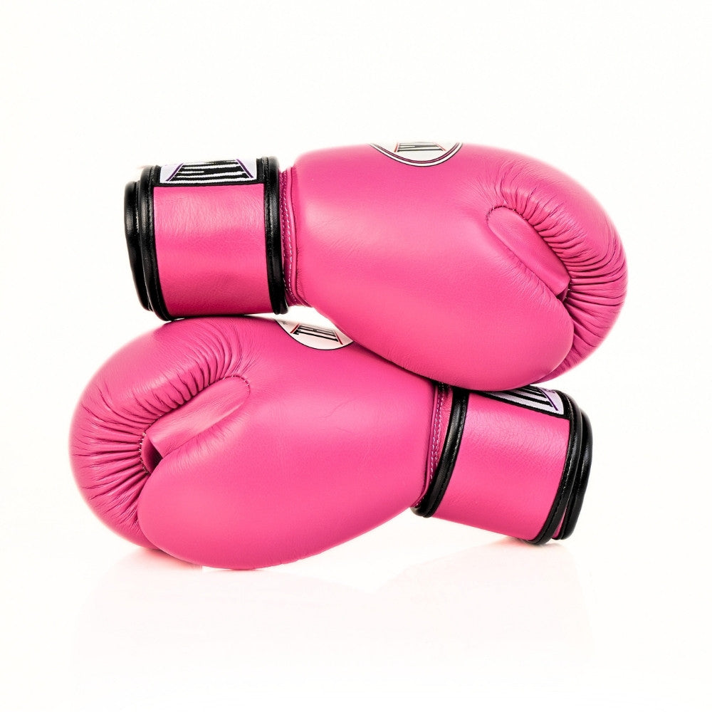 Pink THAISMAI BG124 boxing gloves crossed on a white background, showing the black wrist cuffs, padded striking surfaces and partially visible glove logos.