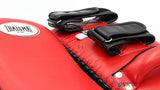 Close-up of a red THAISMAI KP142 Muay Thai kick pad with black double straps, padded target surface and THAISMAI logo.
