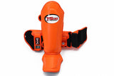 Twins Special SGL-10 shin guards in black synthetic leather with full-length shin and instep protection, secure hook-and-loop straps and padded support for Muay Thai and kickboxing training on a white background