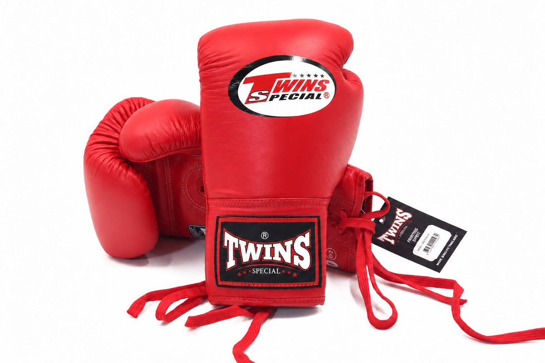 Twins Special BGLL-1 red lace-up boxing gloves with visible Twins logos, premium leather construction, secure lace closure, and attached thumbs on a white background