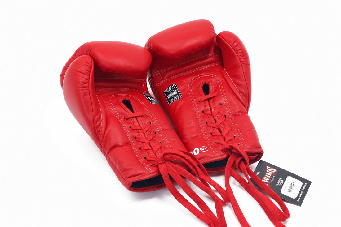 Twins Special BGLL-1 red lace-up boxing gloves in premium Thai leather with secure lace closure, attached thumbs, and competition-style padding on a white background