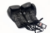 Twins Special BGLL-1 lace-up boxing gloves in black leather with secure lace closure, attached thumbs, and competition-style padding on a white background