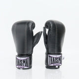 THAISMAI BM111 black Muay Thai bag gloves in genuine leather showing Thaismai branding and compact knuckle padding, pair on a white background