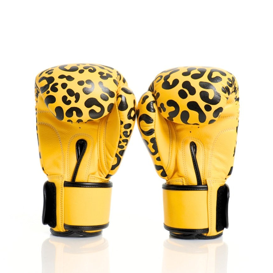 ThaiSmai FBG124 Leopard Muay Thai boxing gloves in genuine leather with yellow-and-black leopard print, padded knuckles and secure wrist support, pair on a white background