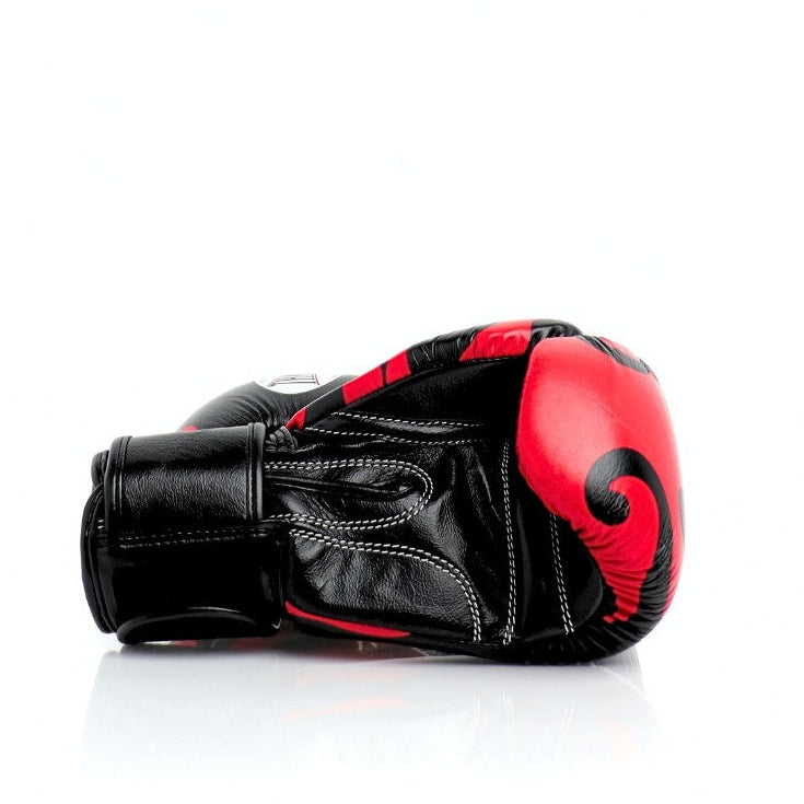 ThaiSmai Flame Muay Thai boxing gloves in black and red genuine leather with high-density foam, ergonomic fist shape and full-wrap Velcro closure on a white background