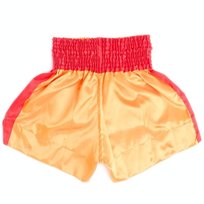 Rear view of gold and red ThaiSmai M-150 Golden Era Muay Thai shorts showing the elastic waistband, red side panels and split-leg cut on a white background