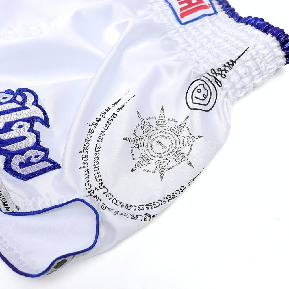 THAISMAI SAK YANT Muay Thai boxing shorts in lightweight satin with Thai lettering, classic side-slit cut and traditional fightwear design on a white background