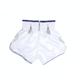 THAISMAI SAK YANT Muay Thai boxing shorts in lightweight satin with Thai lettering, classic side-slit cut and traditional fightwear design on a white background
