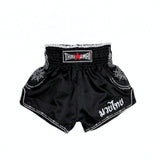 THAISMAI SAK YANT Muay Thai boxing shorts in lightweight satin with Thai lettering, classic side-slit cut and traditional fightwear design on a white background