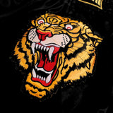 Additional view of black and yellow ThaiSmai TIGER Muay Thai shorts showing the lightweight satin construction and wide side slits on a white background