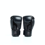 THAISMAI BG124 Muay Thai boxing gloves in black leather with reinforced multi-layer padding, secure hook-and-loop wrist closure and Thaismai branding on a white background