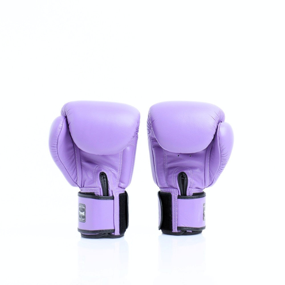 Rear view of a pair of lavender Twins Special boxing gloves showing black hook-and-loop wrist straps on a white background with a soft reflection
