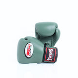 Pair of olive green Twins Special boxing gloves arranged at an angle, with the front glove showing the Twins logo and branded wrist patch on a white background
