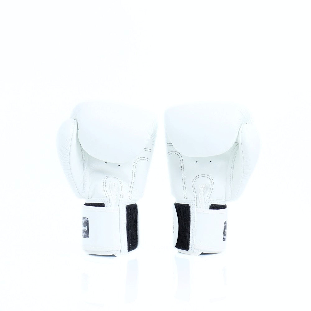 Rear view of a pair of white Twins Special boxing gloves showing black hook-and-loop wrist strap closures on a white background with a soft reflection