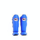 Twins Special SGL-10 shin guards in black synthetic leather with full-length shin and instep protection, secure hook-and-loop straps and padded support for Muay Thai and kickboxing training on a white background