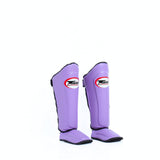 Twins Special SGL-10 shin guards in black synthetic leather with full-length shin and instep protection, secure hook-and-loop straps and padded support for Muay Thai and kickboxing training on a white background