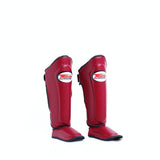 Twins Special SGL-10 shin guards in black synthetic leather with full-length shin and instep protection, secure hook-and-loop straps and padded support for Muay Thai and kickboxing training on a white background