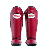 Twins Special SGL-10 shin guards in black synthetic leather with full-length shin and instep protection, secure hook-and-loop straps and padded support for Muay Thai and kickboxing training on a white background