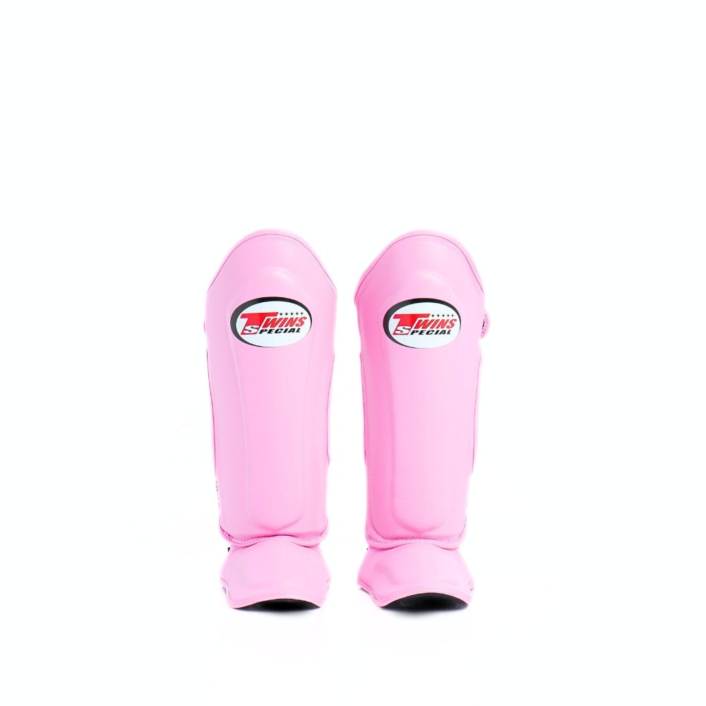 Twins Special SGL-10 shin guards in black synthetic leather with full-length shin and instep protection, secure hook-and-loop straps and padded support for Muay Thai and kickboxing training on a white background