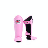 Twins Special SGL-10 shin guards in black synthetic leather with full-length shin and instep protection, secure hook-and-loop straps and padded support for Muay Thai and kickboxing training on a white background