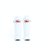 Twins Special SGL-10 shin guards in black synthetic leather with full-length shin and instep protection, secure hook-and-loop straps and padded support for Muay Thai and kickboxing training on a white background