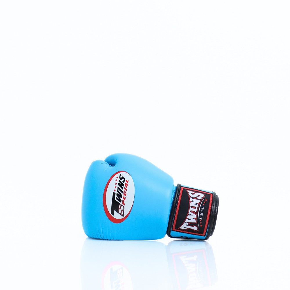 Light blue Twins Special BGVL-3 boxing glove viewed from the side with its wrist strap visible.