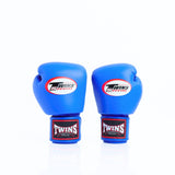 Pair of bright blue Twins Special boxing gloves shown front-facing with Twins logos and branded red-and-black wrist patches on a white background