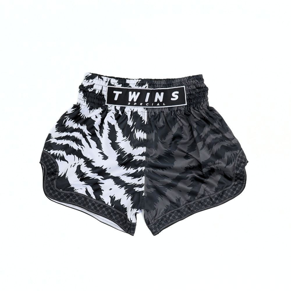 Twins Special TBS-JUNGLE Muay Thai boxing shorts with black and white tiger-stripe and dark textured jungle design, traditional side-slit cut and secure elastic waistband on a white background
