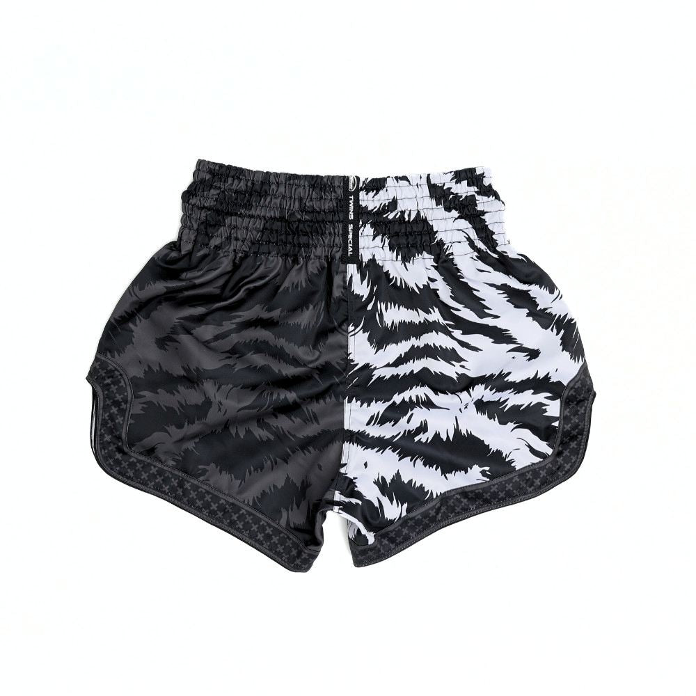 Twins Special TBS-JUNGLE Muay Thai boxing shorts with black and white tiger-stripe and dark textured jungle design, traditional side-slit cut and secure elastic waistband on a white background
