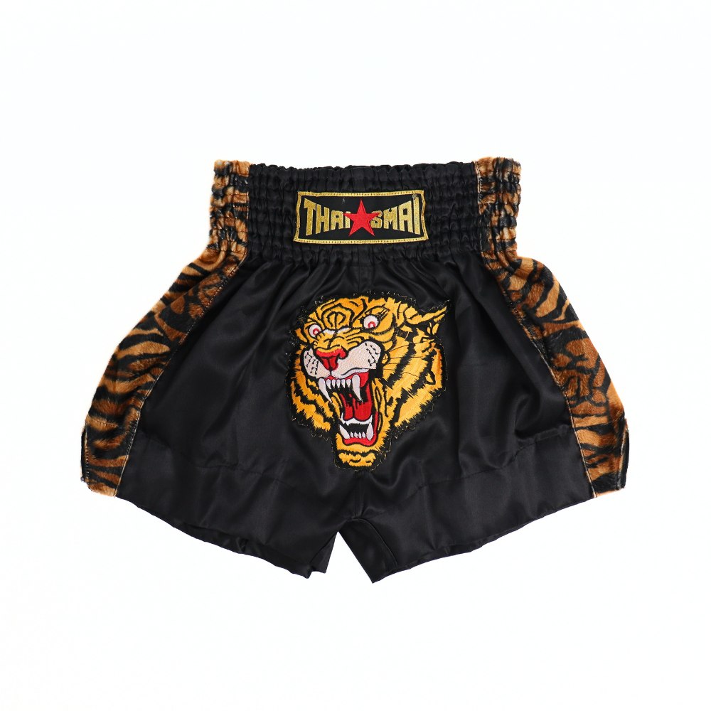 Front view of black and yellow ThaiSmai TIGER Muay Thai shorts with bold tiger artwork, elastic waistband and traditional side-slit cut on a white background