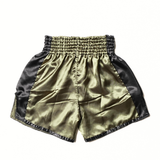 Rear view of olive and black Windy classic satin Muay Thai shorts showing the elastic waistband, side-slit cut and lightweight training fabric on a white background