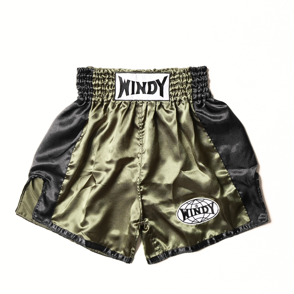 Front view of olive and black Windy classic satin Muay Thai shorts showing the elastic waistband, white Windy branding, circular logo patch and side-slit design on a white background