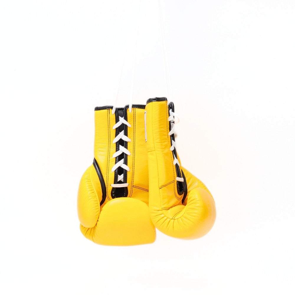 Additional view of yellow Windy BGL lace-up boxing gloves showing white laces, stitched leather, black edging and padded wrist construction on a white background