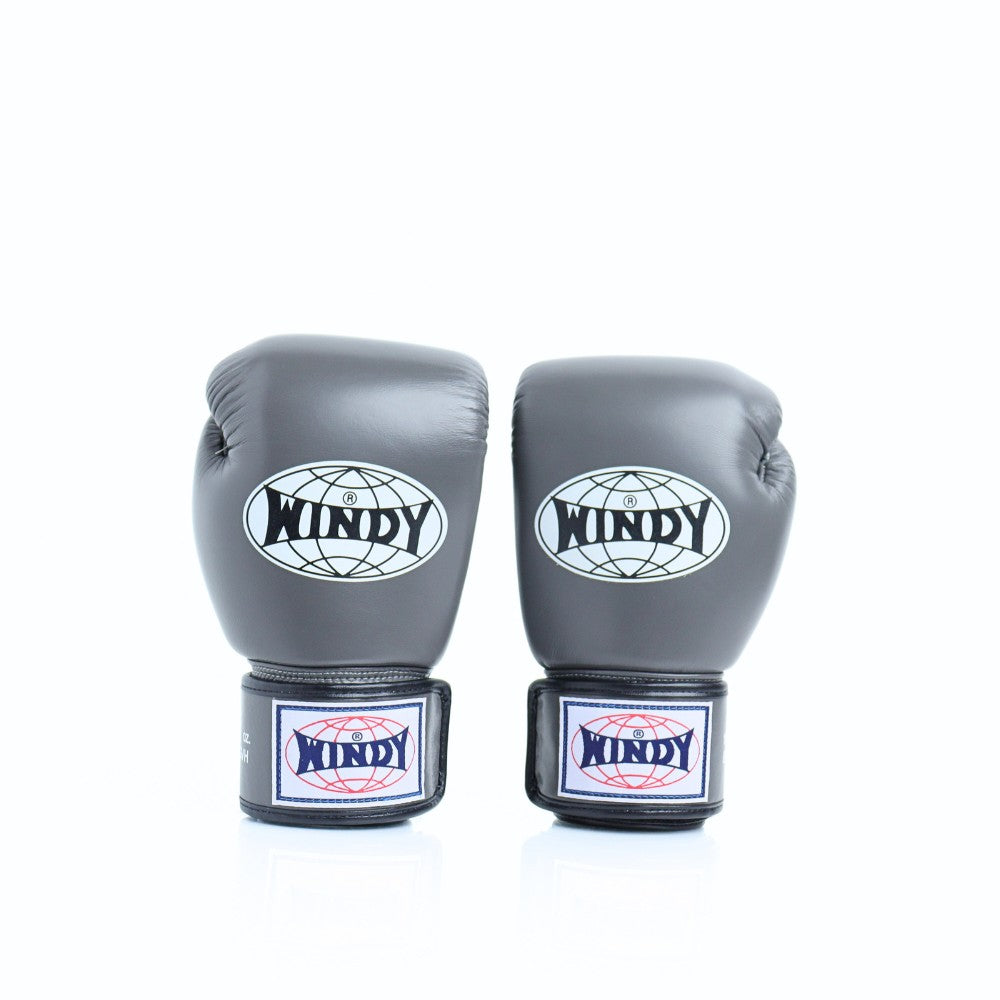 Front view of a pair of gray Windy BGVH leather Muay Thai boxing gloves showing padded knuckles, Windy logos, wrist straps and hook-and-loop closures on a white background