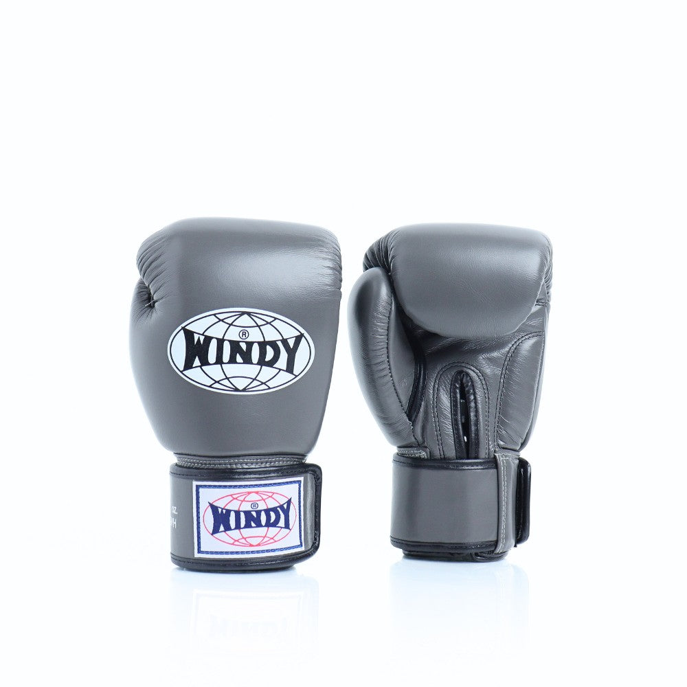 Front view of grey Windy BGVH Muay Thai boxing gloves showing padded knuckles, thumb protection, wrist cuffs and Windy branding on a white background