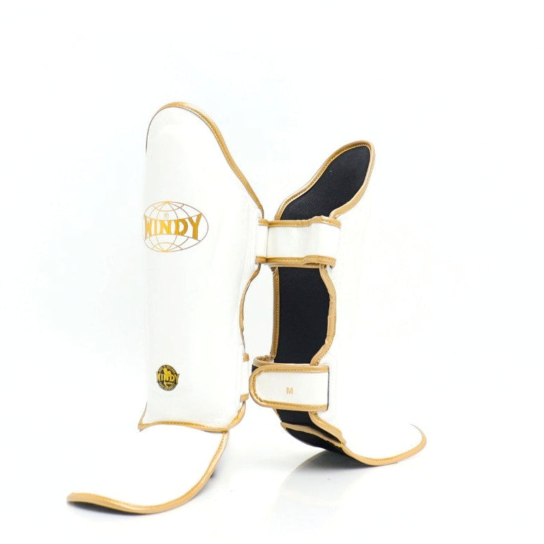 Windy LP3 white and gold Muay Thai shin guards with full-length leg and instep protection, padded shin support and Windy branding on a white background