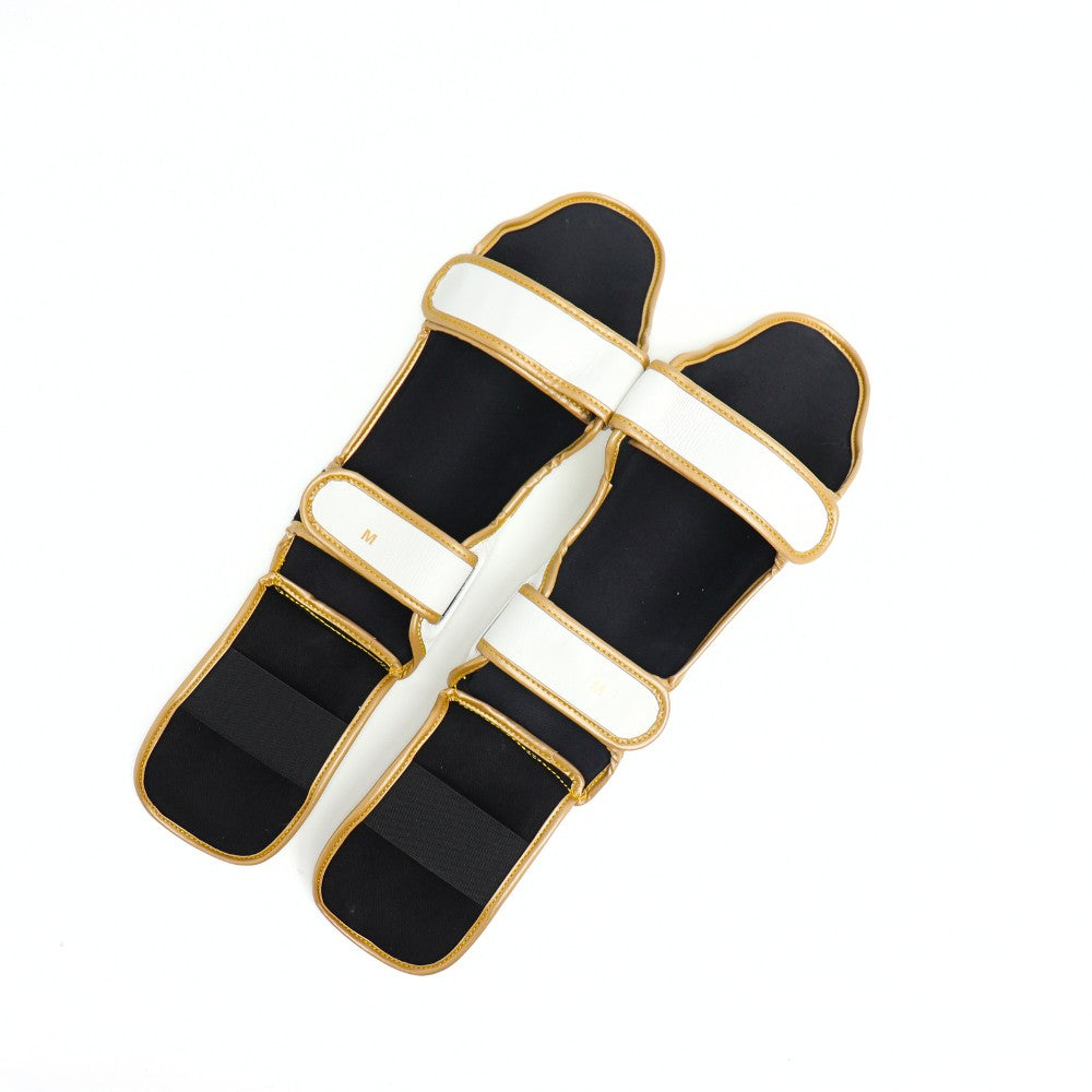 Windy LP3 white and gold Muay Thai shin guards with full-length leg and instep protection, padded shin support and Windy branding on a white background